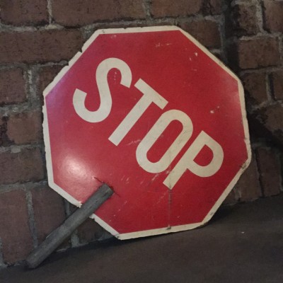 handheld STOP SLOW sign